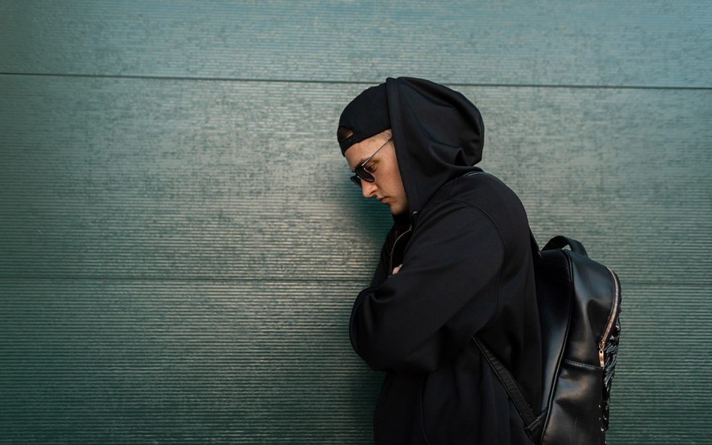 men posing with a hoodie and glasses