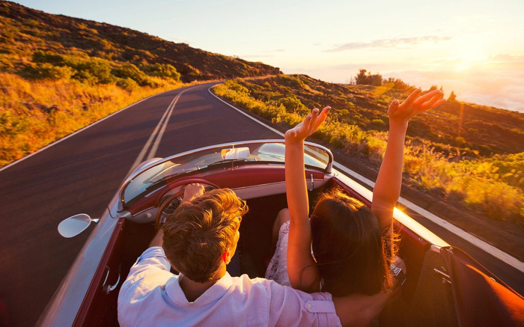 couple driving a convertible