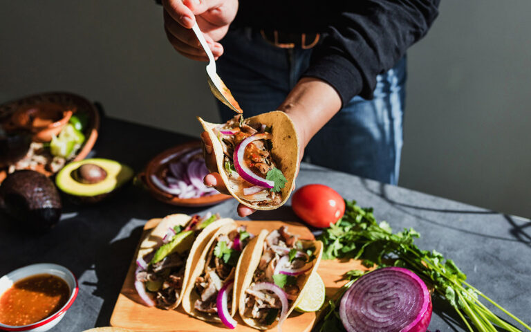 man preparing tacos