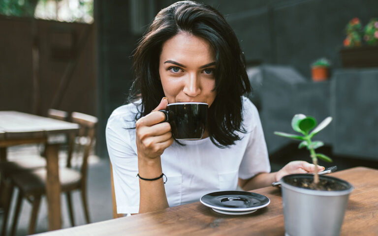 woman drinking coffee at a coffee shop