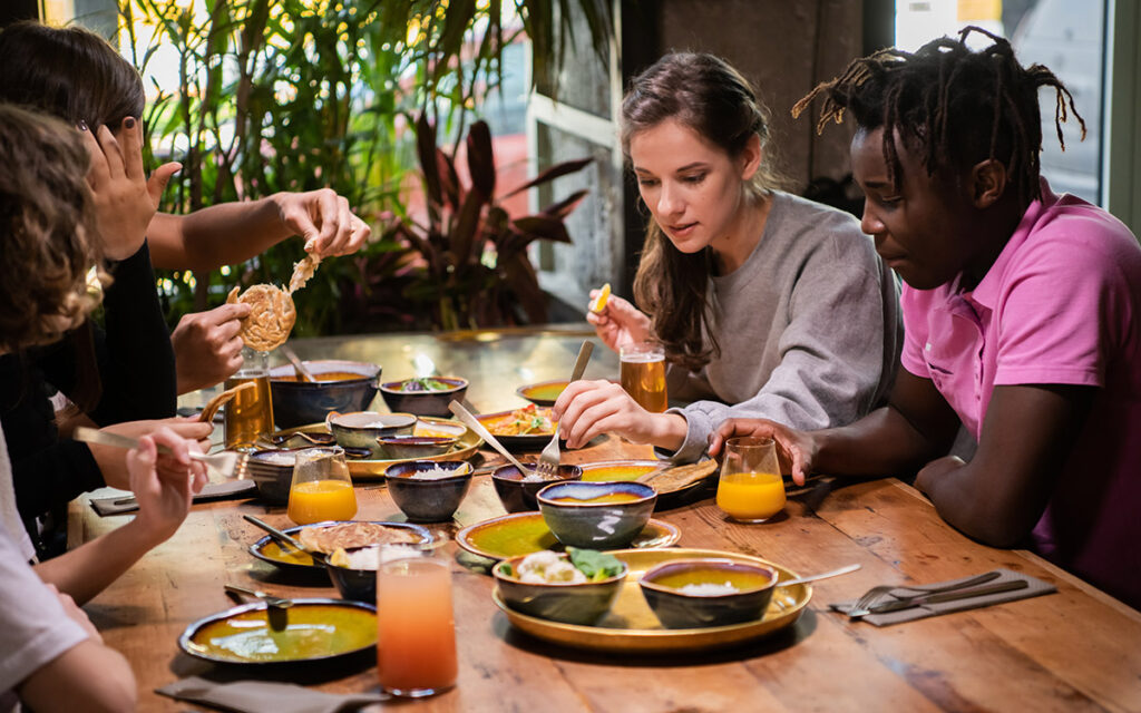 friends eating at a restaurant while traveling